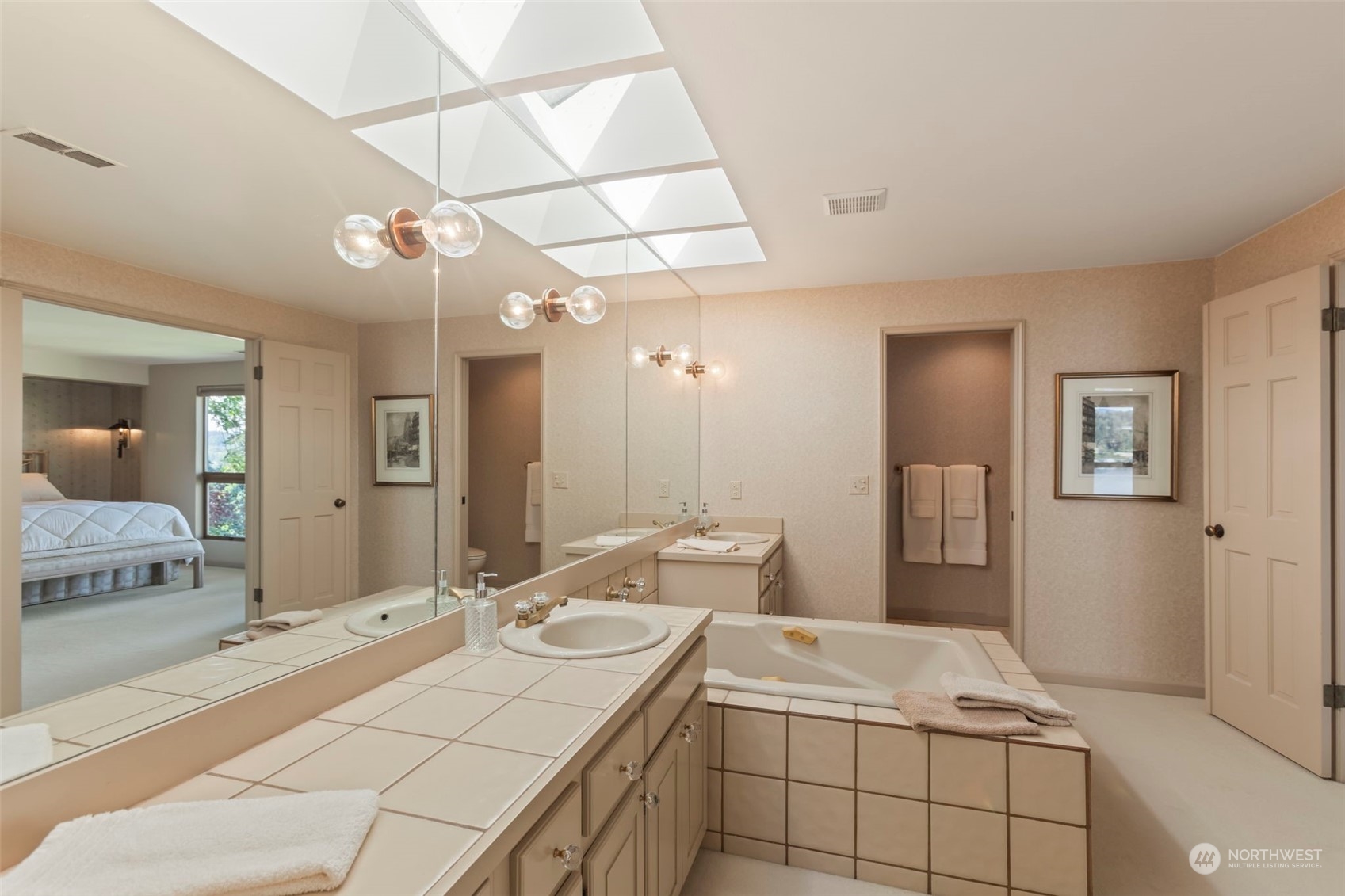 6244 East Mercer Way Mercer Island, WA 98040 - Photo 25 of 40 a bathroom with a sink double vanity granite and a mirror