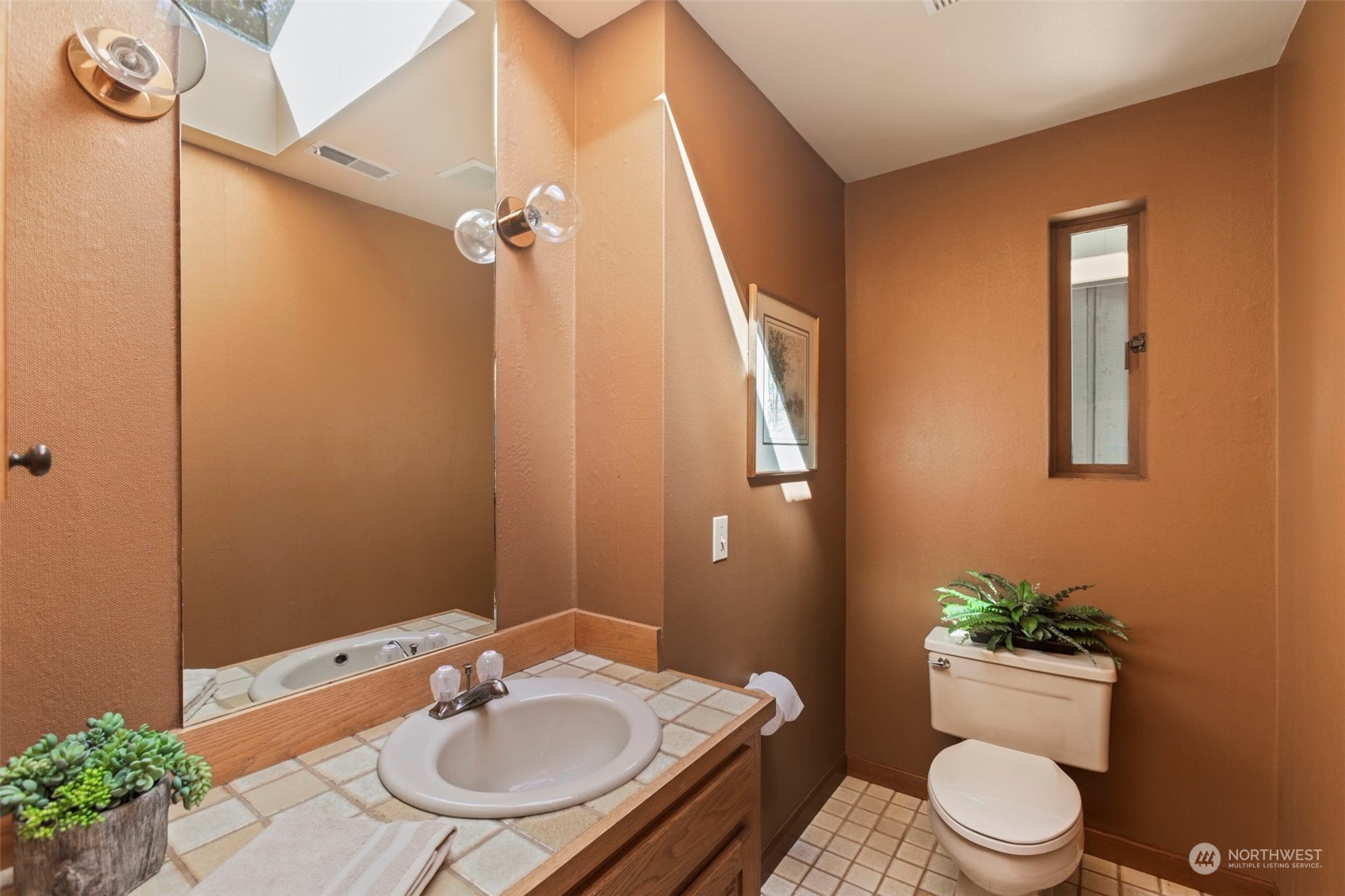6244 East Mercer Way Mercer Island, WA 98040 - Photo 28 of 40 a bathroom with a sink a toilet and shower