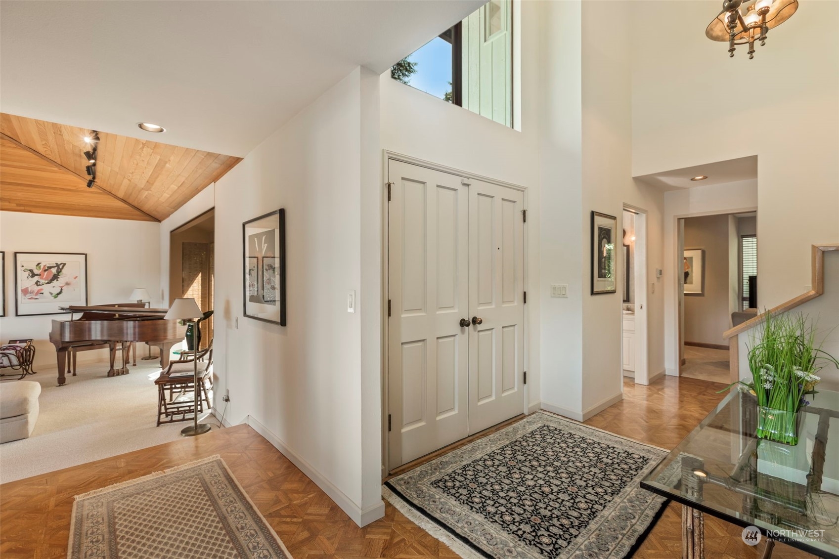 6244 East Mercer Way Mercer Island, WA 98040 - Photo 3 of 40 a view of a bedroom with wooden floor and windows