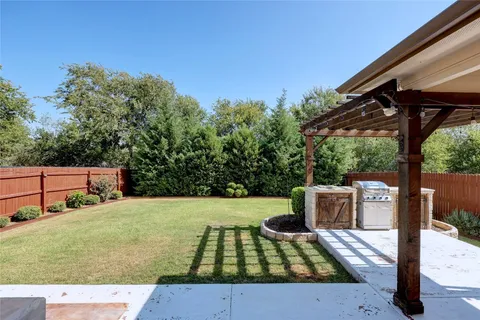 a view of a patio with table and chairs and potted plants