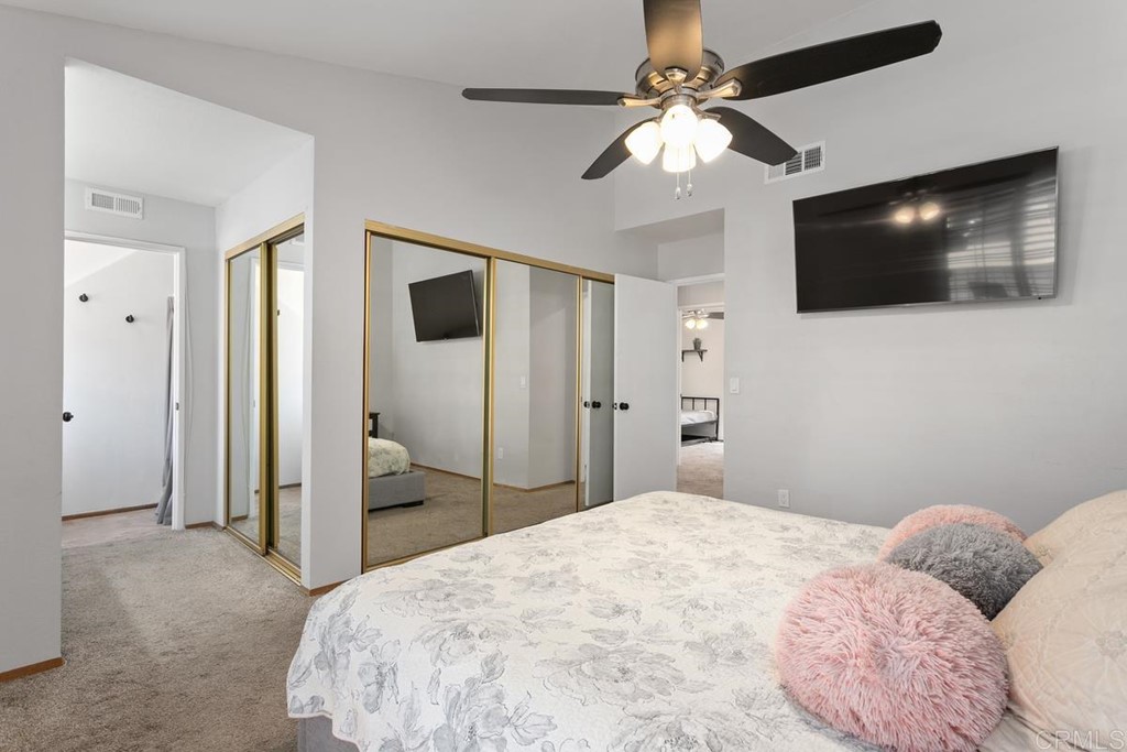 1145 Privet Street San Marcos, CA 92069 - Photo 11 of 24 a bedroom with a large bed a flat tv screen and fan