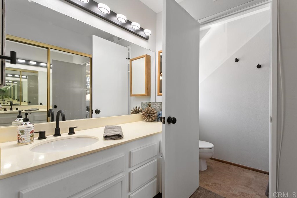 1145 Privet Street San Marcos, CA 92069 - Photo 12 of 24 a bathroom with a double vanity sink a toilet and a mirror