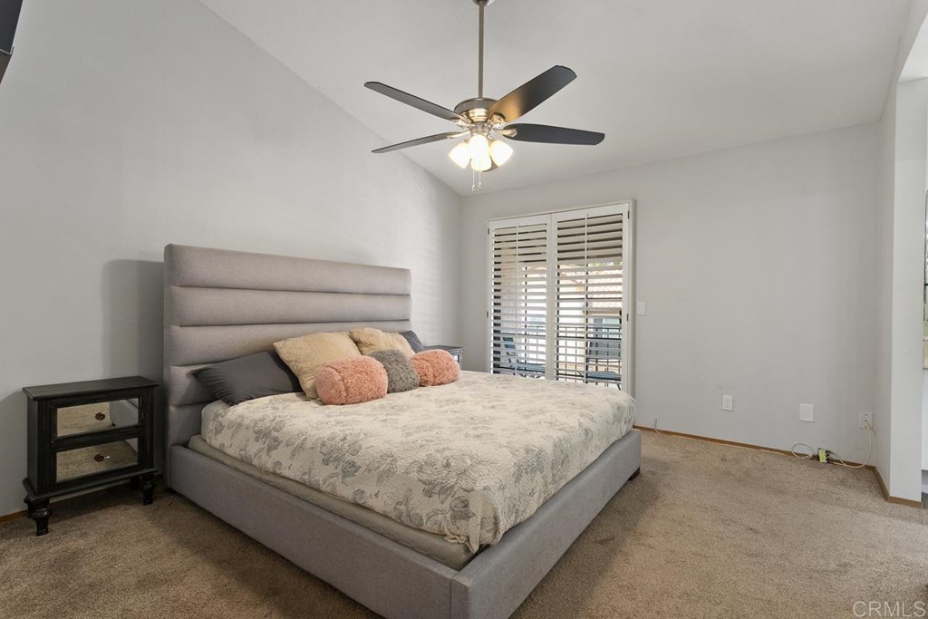 1145 Privet Street San Marcos, CA 92069 - Photo 10 of 24 a bedroom with a bed and a chandelier