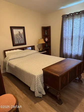a bedroom with a bed and a dresser