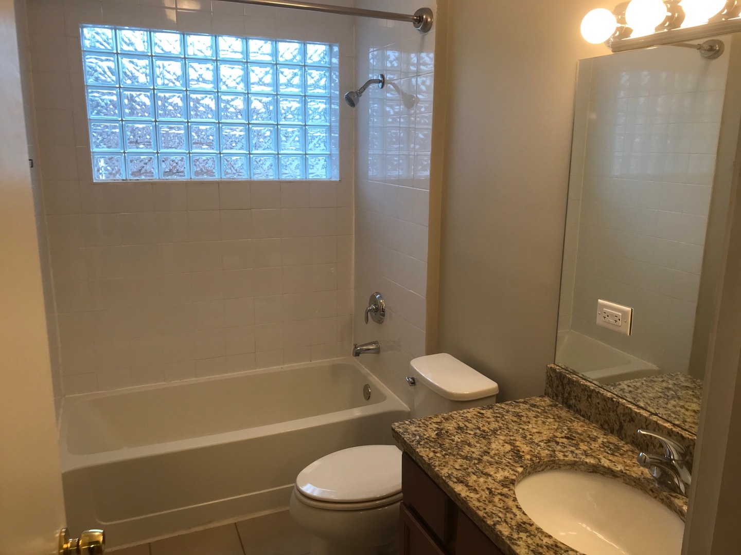 720 Timber Hill Road Deerfield, IL 60015 - Photo 22 of 24 a bathroom with a granite countertop toilet a sink and a bathtub