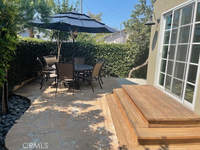 5255 Sylmar Avenue Sherman Oaks, CA 91401 - Photo 13 of 13 a view of a patio with table and chairs under an umbrella