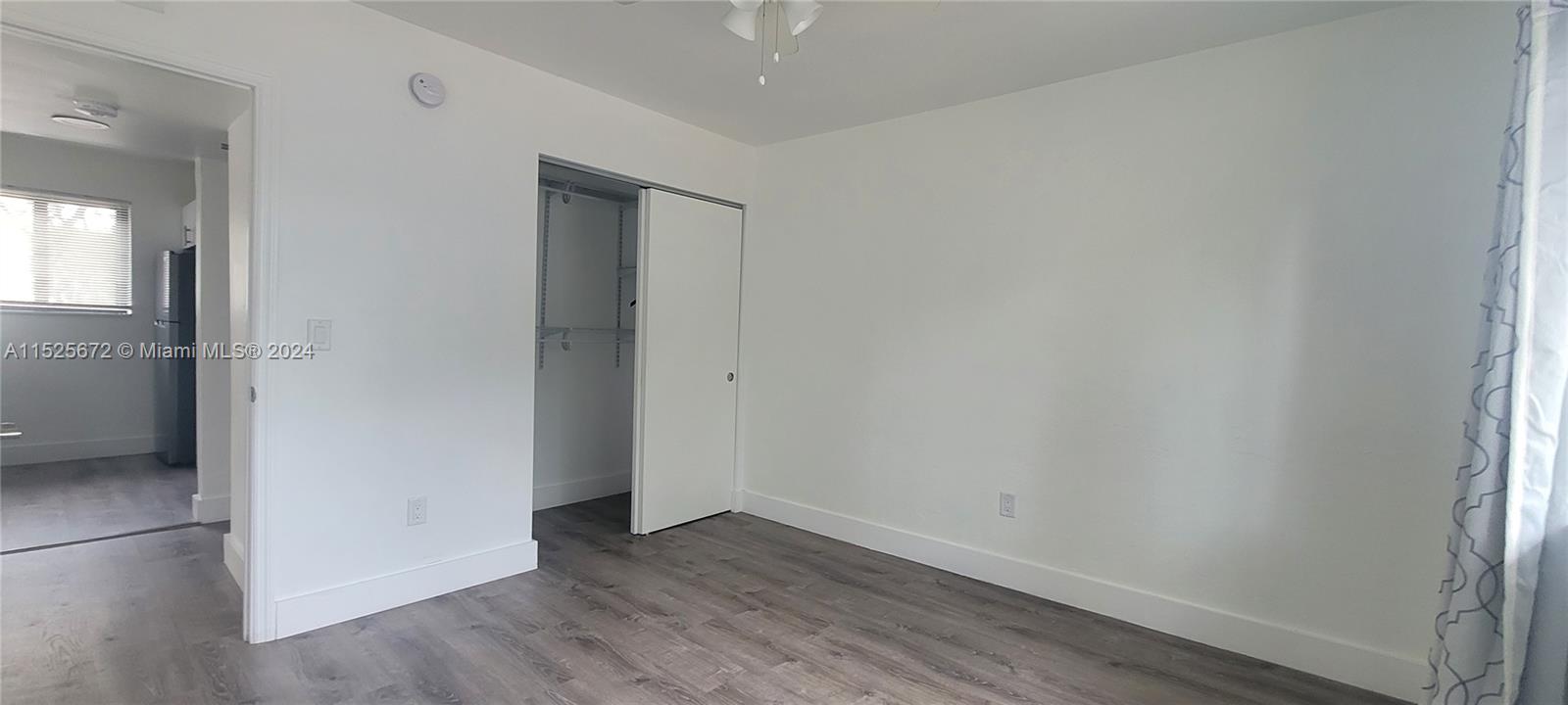 Silver Bluff Miami, FL 33133 - Photo 4 of 12 an empty room with wooden floor and a window