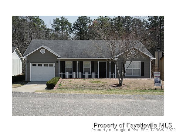 6435 Applewhite Road Fayetteville, NC 28304 - Photo 1 of 10 a front view of a house with a garden