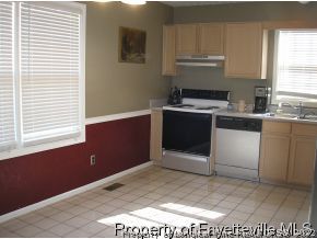 6435 Applewhite Road Fayetteville, NC 28304 - Photo 3 of 10 a kitchen with a stove and a refrigerator