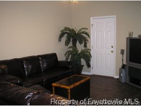 6435 Applewhite Road Fayetteville, NC 28304 - Photo 6 of 10 a living room with furniture and a flat screen tv