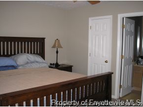 6435 Applewhite Road Fayetteville, NC 28304 - Photo 7 of 10 a bedroom with a bed and wooden floor