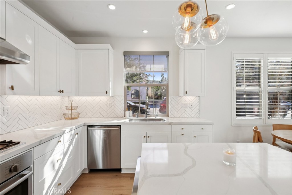 151 Soaring Eagle Irvine, CA 92618 - Photo 11 of 57 a kitchen with a sink stove and cabinets