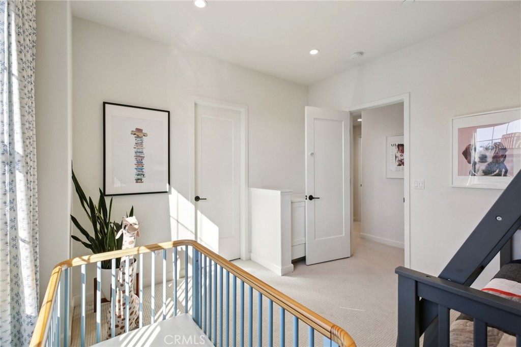 151 Soaring Eagle Irvine, CA 92618 - Photo 17 of 57 a view of a hallway with wooden floor and stairs