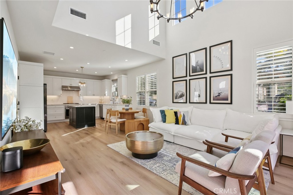 151 Soaring Eagle Irvine, CA 92618 - Photo 2 of 57 a living room with furniture kitchen view and a chandelier