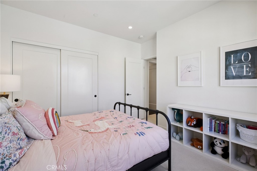 151 Soaring Eagle Irvine, CA 92618 - Photo 23 of 57 a bedroom with a bed a dresser and book shelf