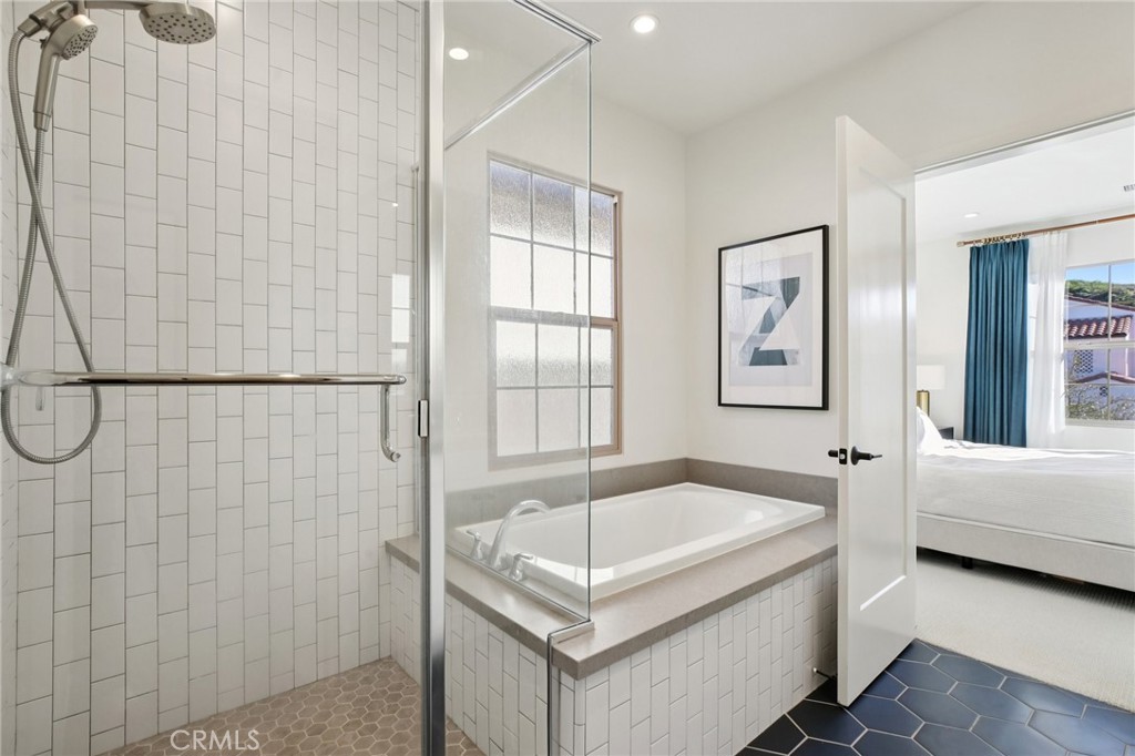 151 Soaring Eagle Irvine, CA 92618 - Photo 26 of 57 a bathroom with a tub a window and a shower