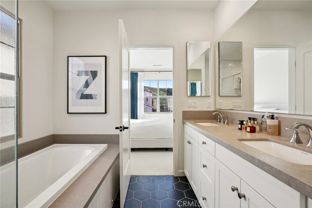 151 Soaring Eagle Irvine, CA 92618 - Photo 28 of 57 a bathroom with a tub a sink and a window