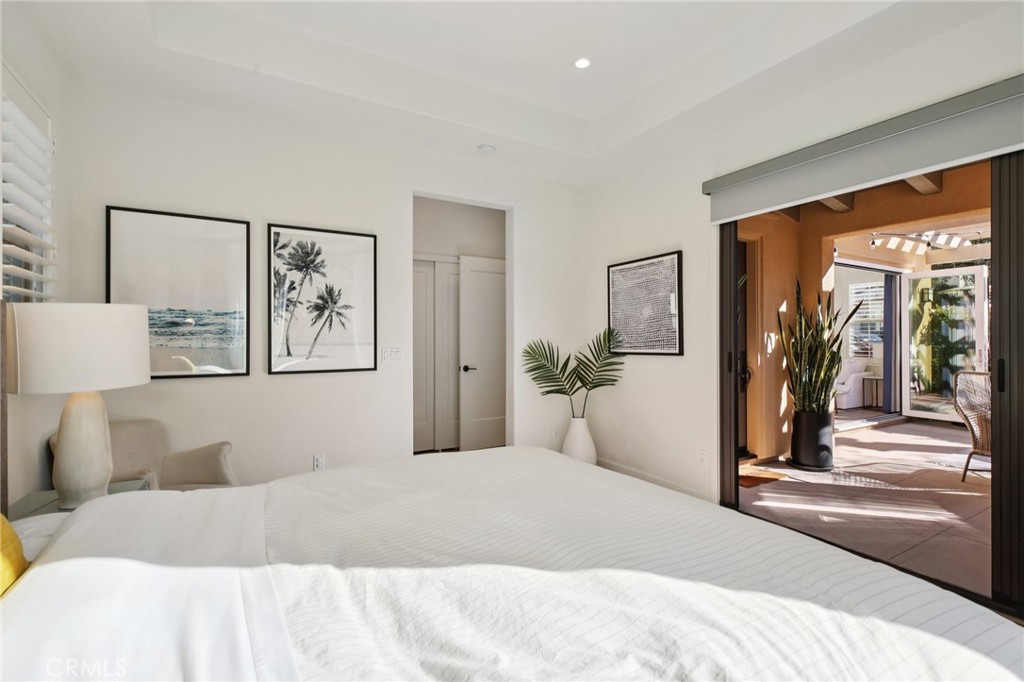 151 Soaring Eagle Irvine, CA 92618 - Photo 34 of 57 a bedroom with a large bed and a painting on the wall