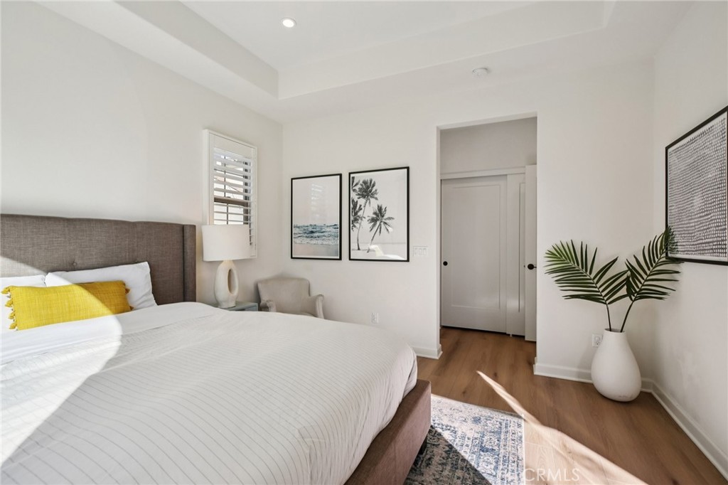 151 Soaring Eagle Irvine, CA 92618 - Photo 35 of 57 a bedroom with a large bed and a potted plant