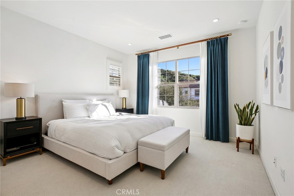 151 Soaring Eagle Irvine, CA 92618 - Photo 40 of 57 a bedroom with a large bed and a large window