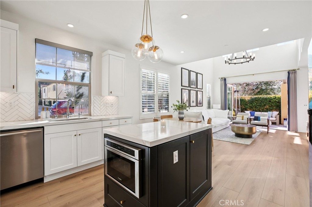 151 Soaring Eagle Irvine, CA 92618 - Photo 4 of 57 a kitchen with a sink stove and wooden cabinets