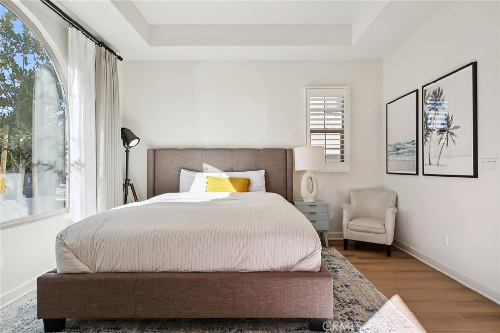 151 Soaring Eagle Irvine, CA 92618 - Photo 49 of 57 a bedroom with a bed and wooden floor