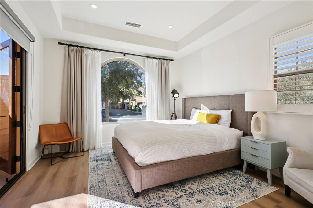 151 Soaring Eagle Irvine, CA 92618 - Photo 50 of 57 a bedroom with a bed a lamp and a large window