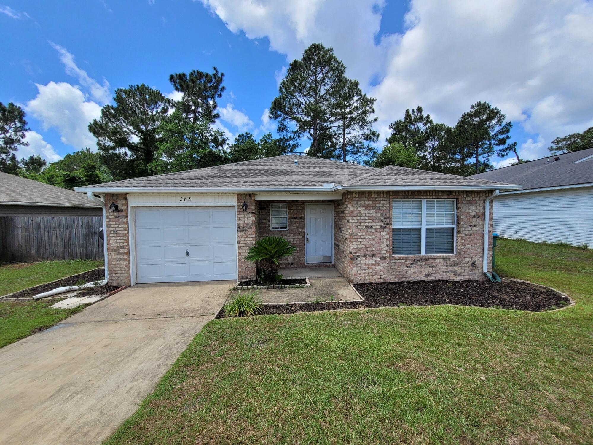 268 Limestone Circle Crestview, FL 32539 - Photo 1 of 23 a front view of a house with a yard and garage
