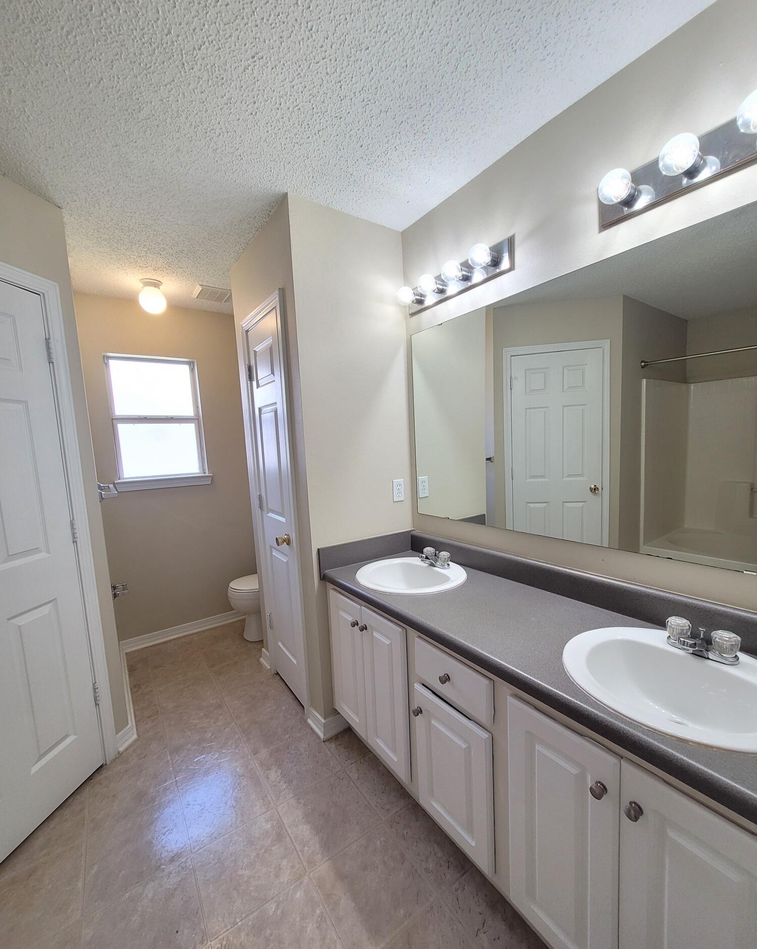 268 Limestone Circle Crestview, FL 32539 - Photo 16 of 23 a bathroom with double sink and a mirror