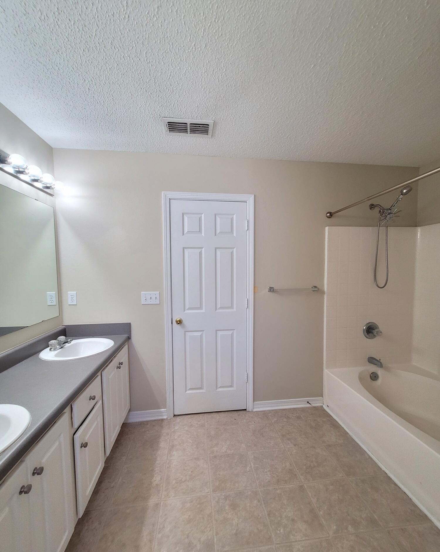 268 Limestone Circle Crestview, FL 32539 - Photo 20 of 23 a bathroom with a granite countertop sink a toilet a mirror and shower