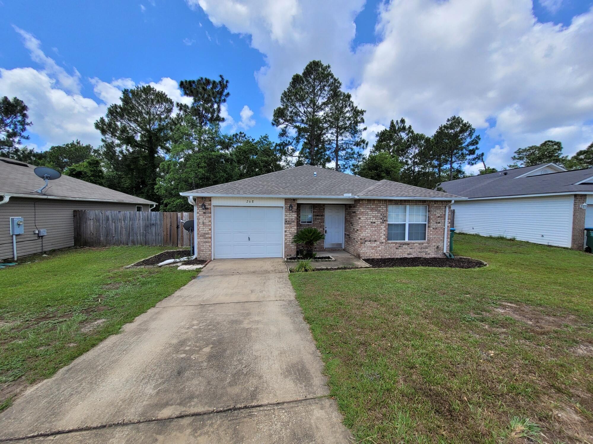 268 Limestone Circle Crestview, FL 32539 - Photo 2 of 23 a front view of a house with a yard and green space