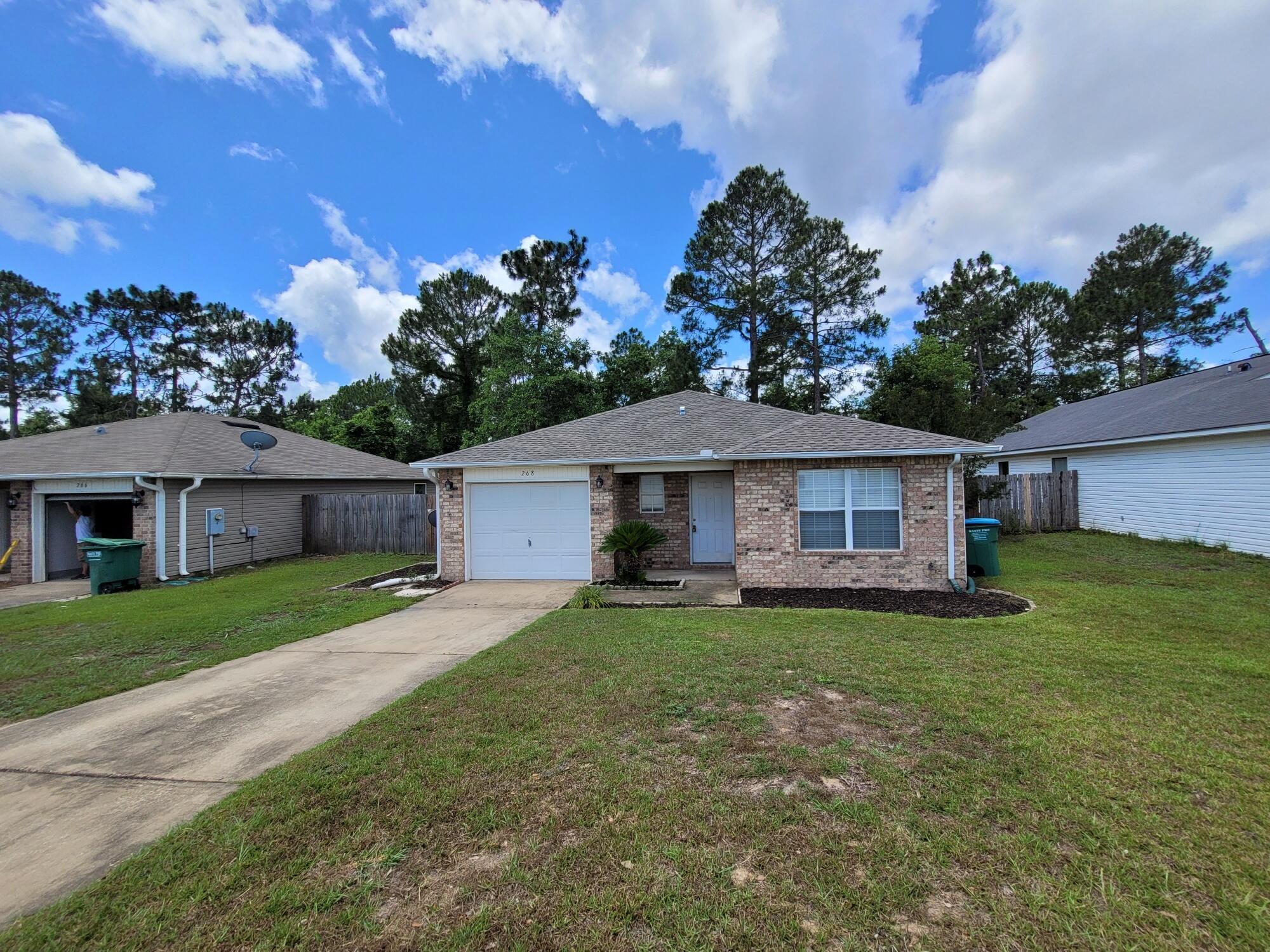 268 Limestone Circle Crestview, FL 32539 - Photo 3 of 23 a white house with a big yard plants and large trees