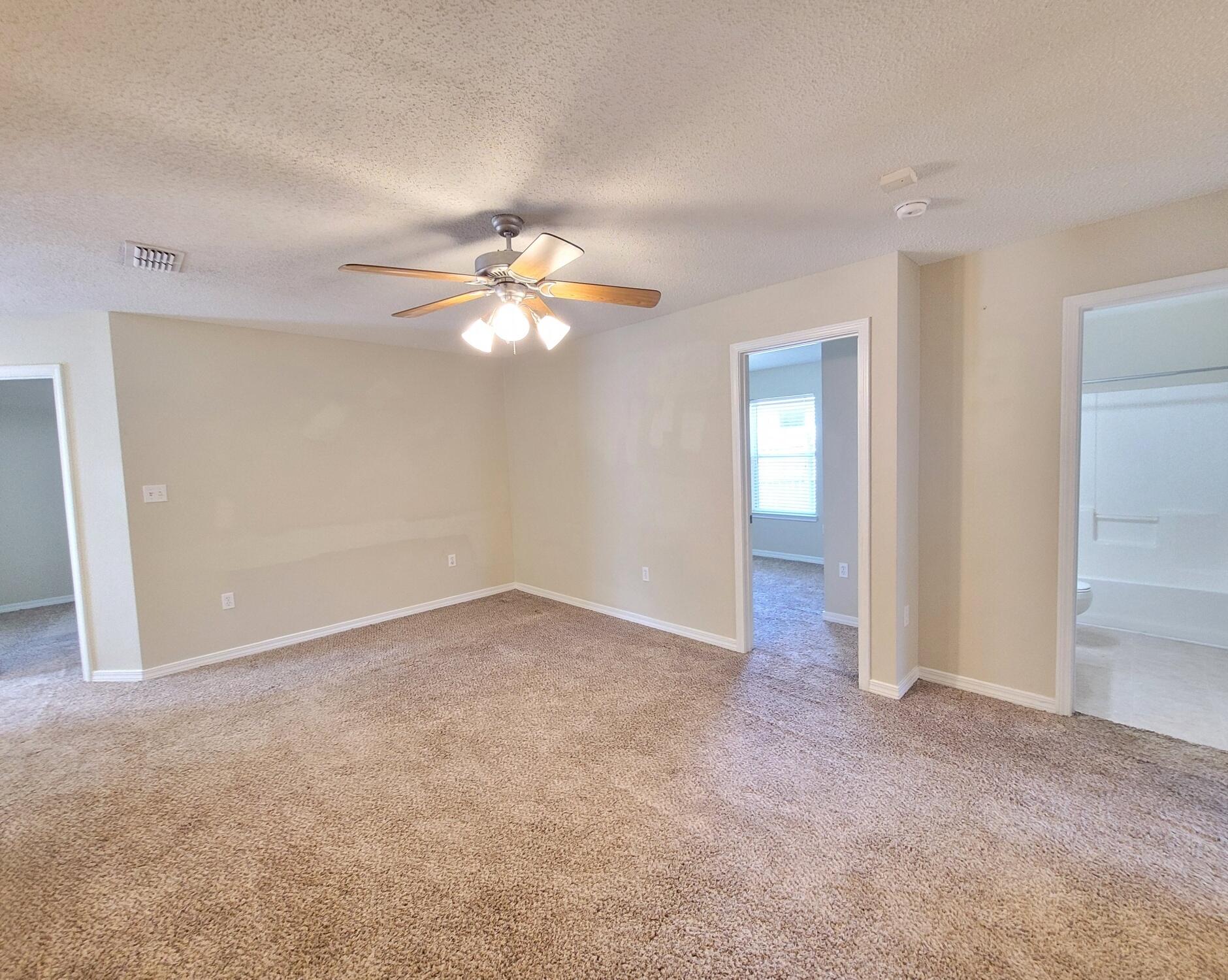 268 Limestone Circle Crestview, FL 32539 - Photo 5 of 23 an empty room with windows and chandelier fan