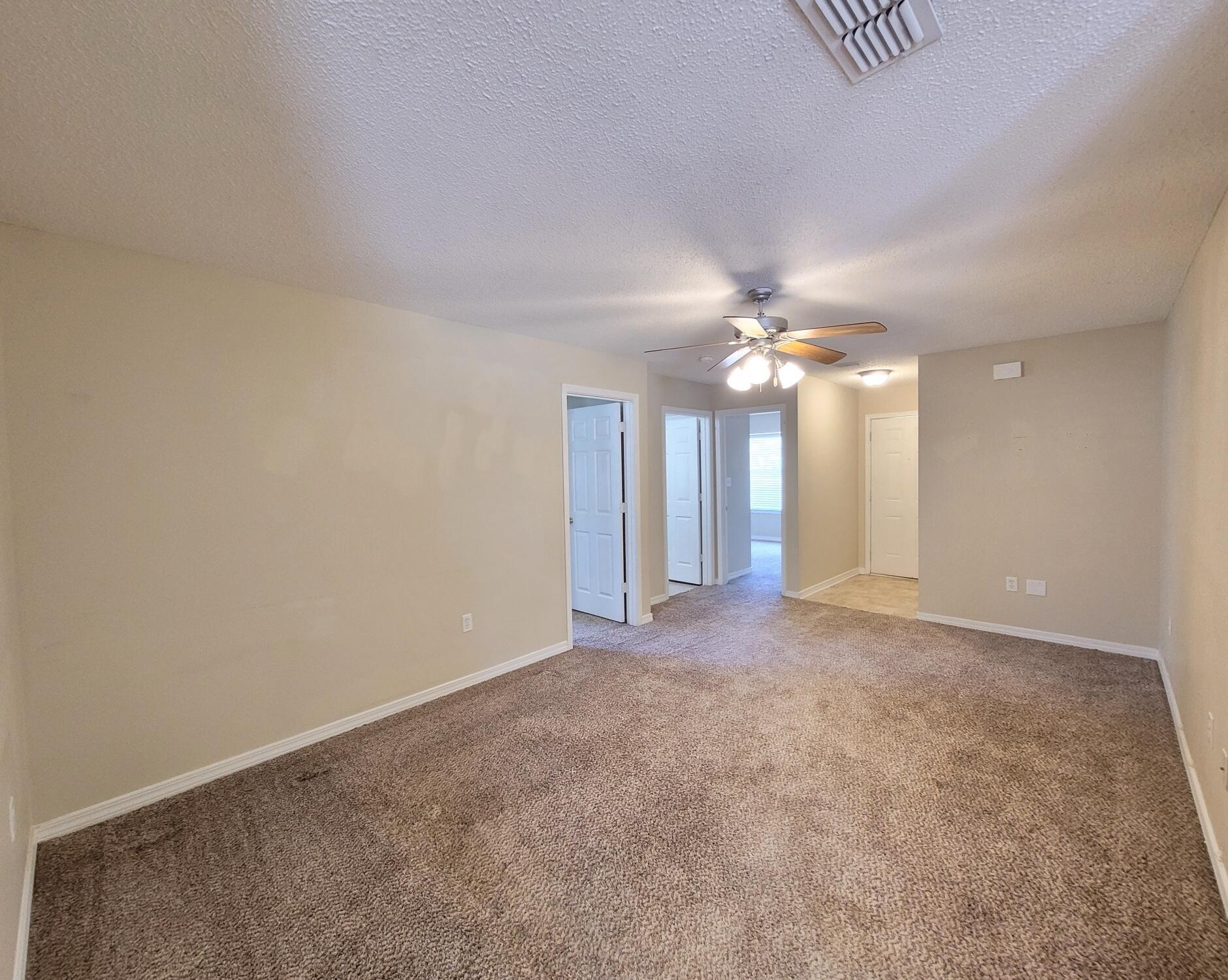 268 Limestone Circle Crestview, FL 32539 - Photo 6 of 23 a view of an empty room with a ceiling fan