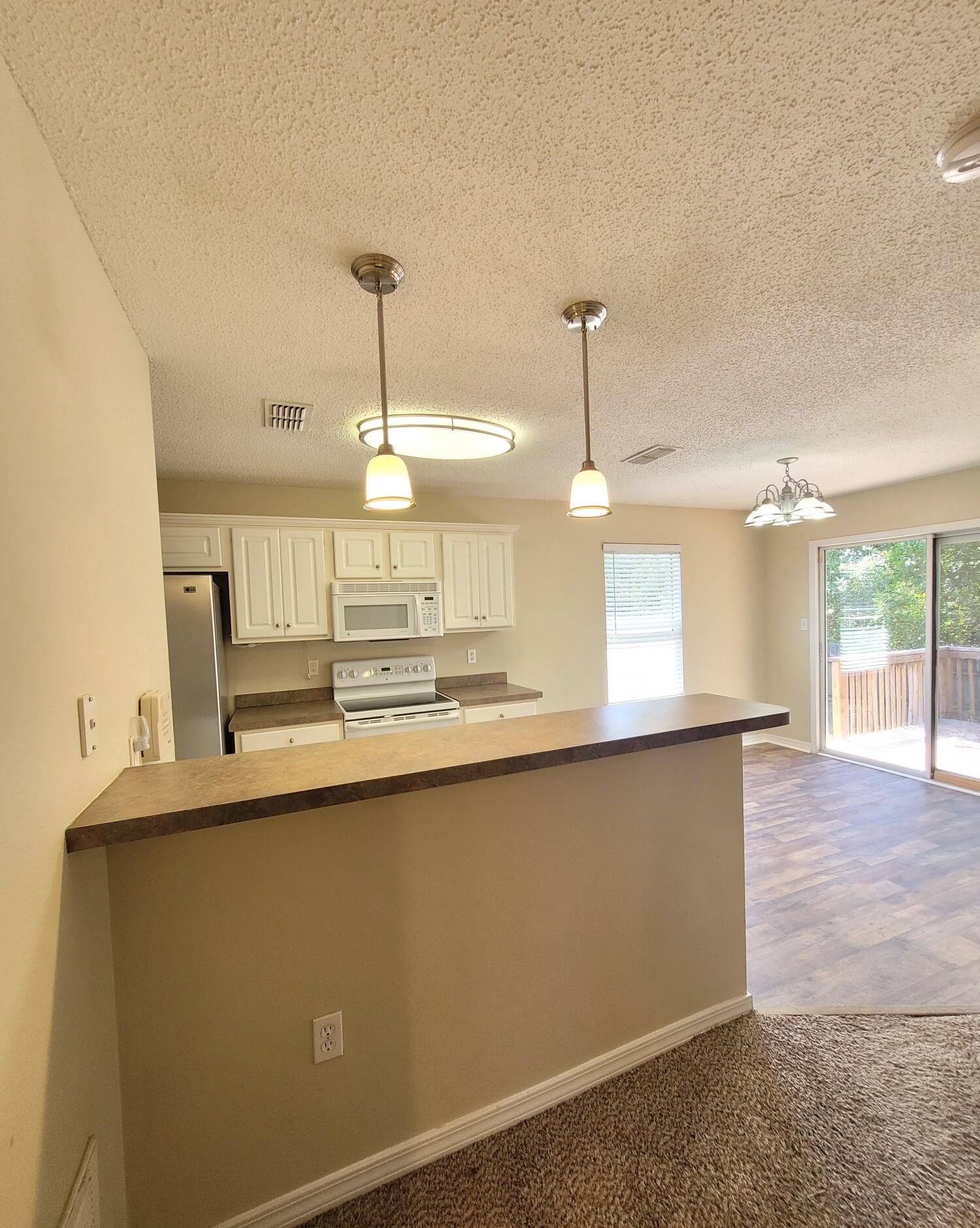 268 Limestone Circle Crestview, FL 32539 - Photo 7 of 23 a kitchen with counter top a sink and chandelier