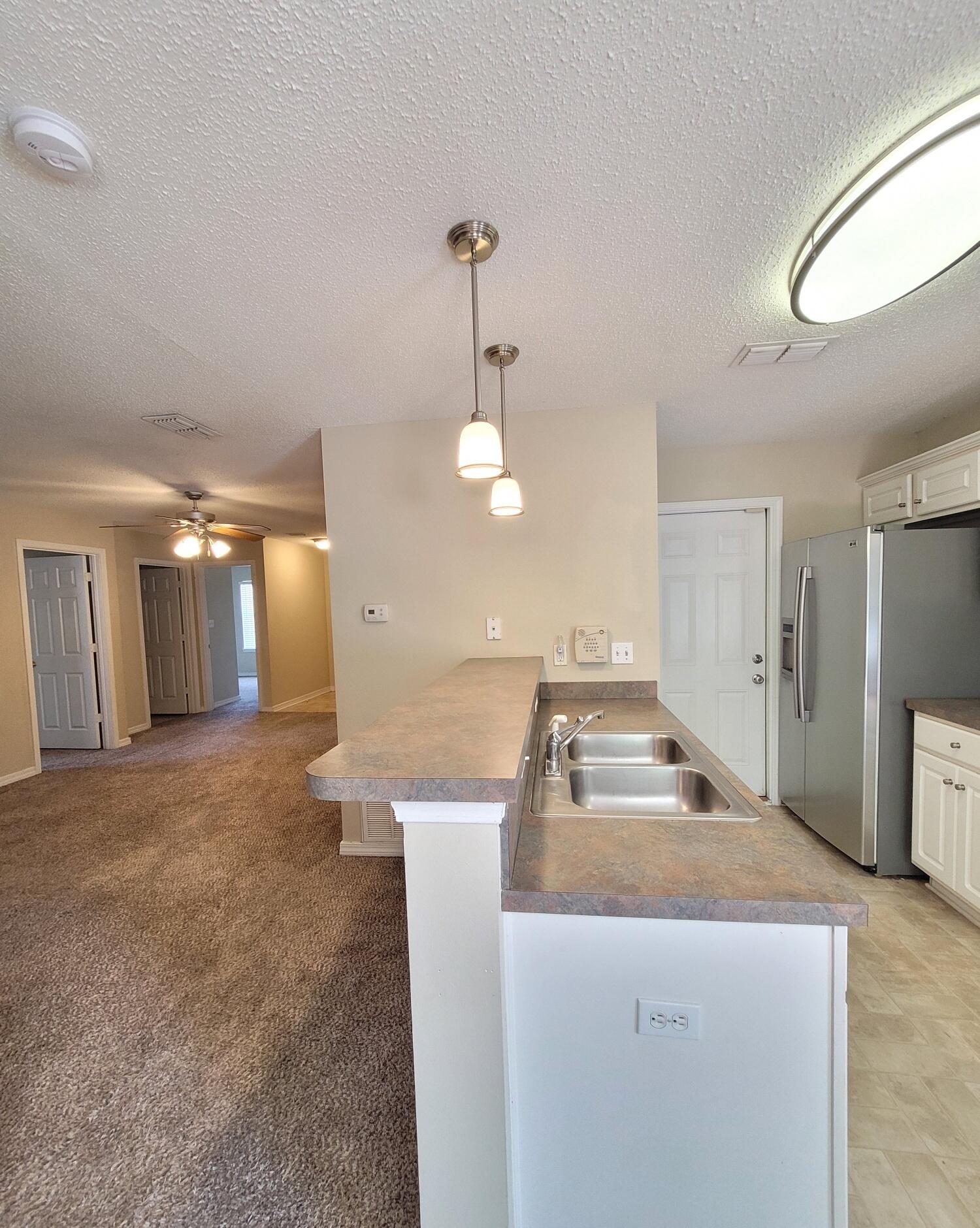 268 Limestone Circle Crestview, FL 32539 - Photo 10 of 23 a room with lot of counter space and a chandelier