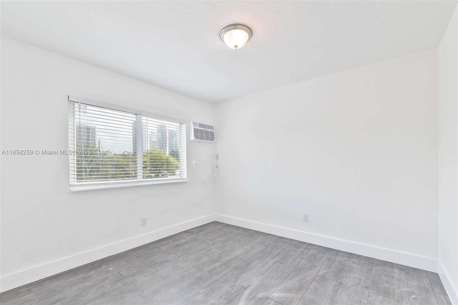 212 Northwest 15th Street, Unit 2 Miami, FL 33136 - Photo 16 of 19 an empty room with a window