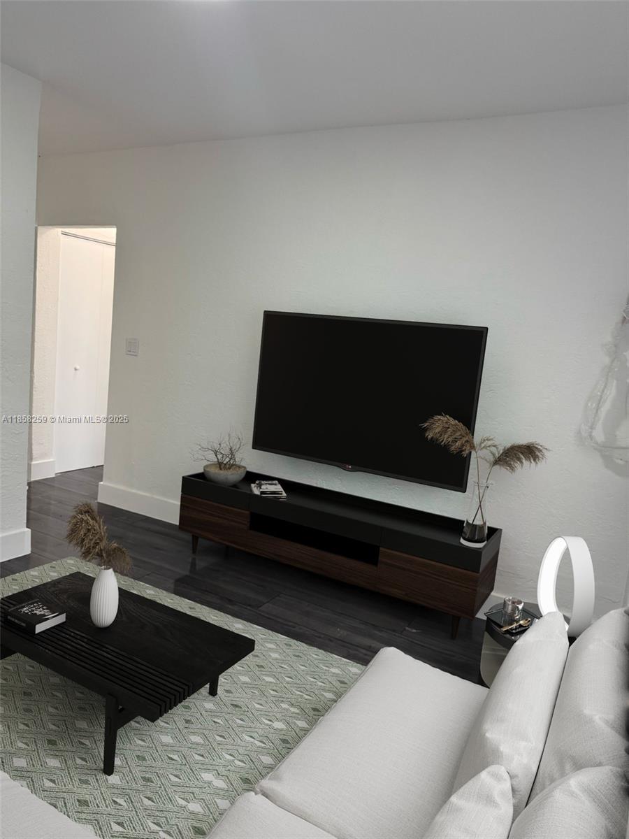 212 Northwest 15th Street, Unit 2 Miami, FL 33136 - Photo 4 of 19 a living room with furniture and a flat screen tv