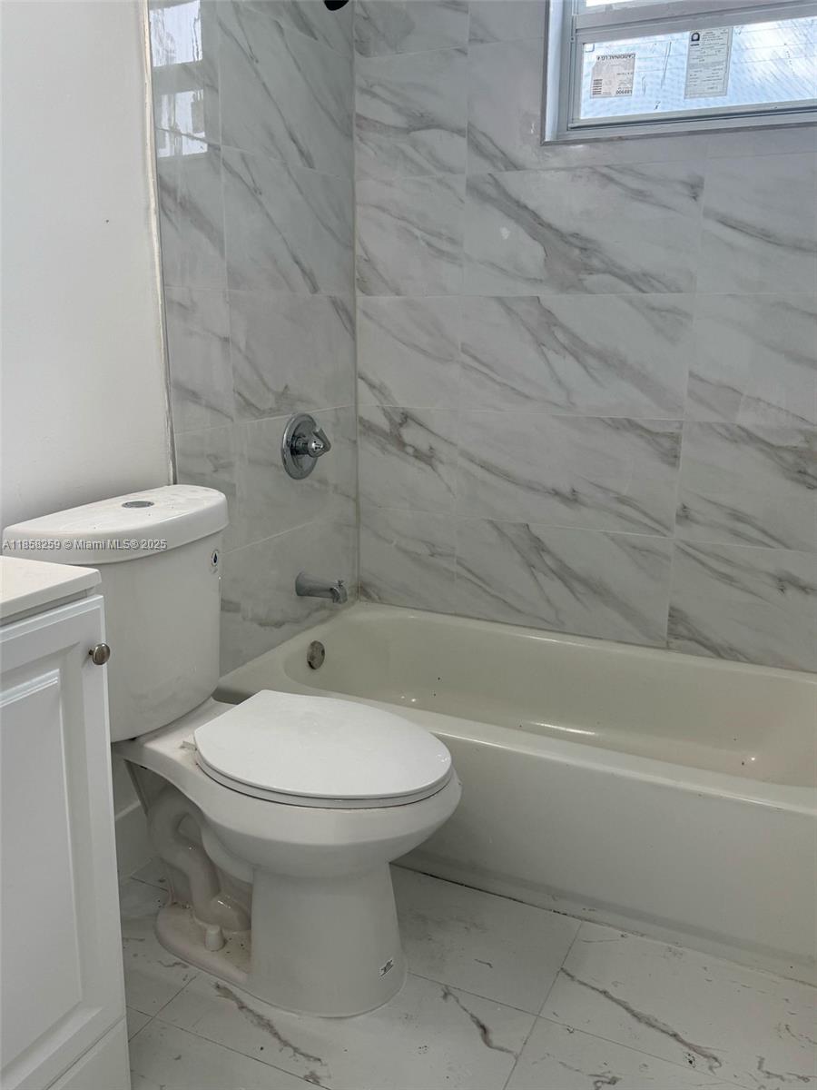 212 Northwest 15th Street, Unit 2 Miami, FL 33136 - Photo 6 of 19 a bathroom with a toilet and a shower