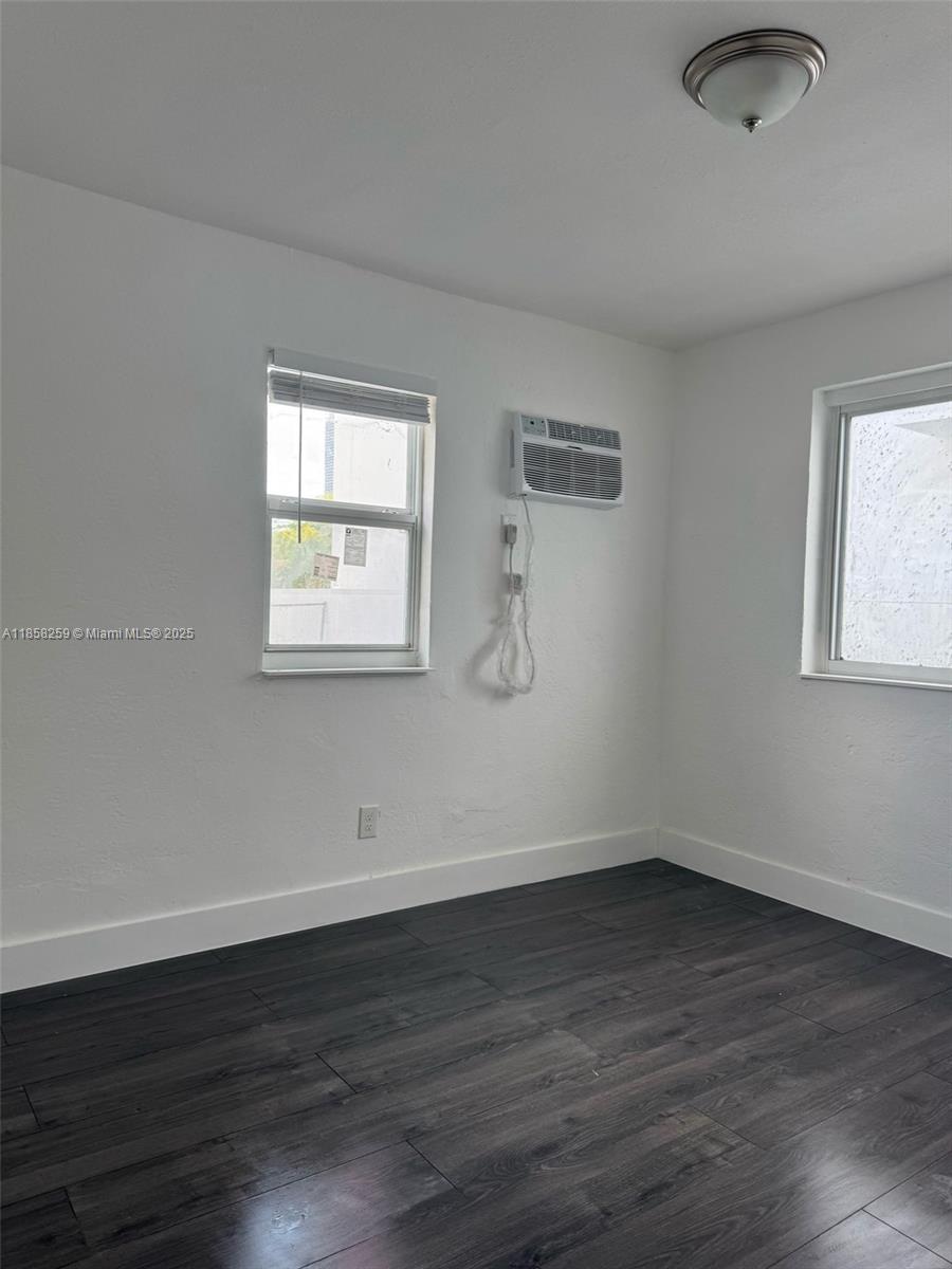 212 Northwest 15th Street, Unit 2 Miami, FL 33136 - Photo 8 of 19 a view of a room that has wooden floor and windows