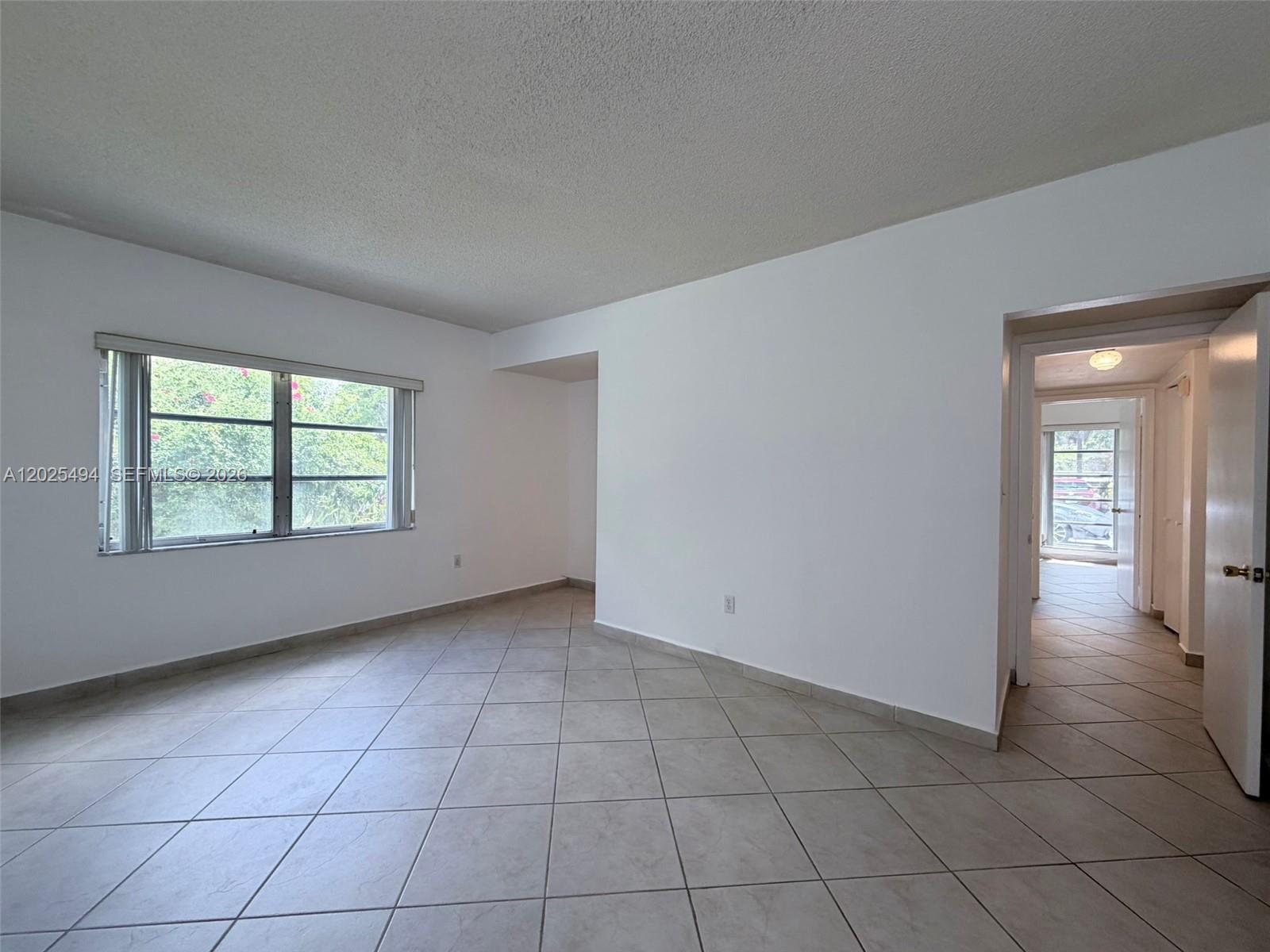 9159 Southwest 77th Avenue, Unit 112 Miami, FL 33156 - Photo 27 of 38 an empty room with entrance and windows