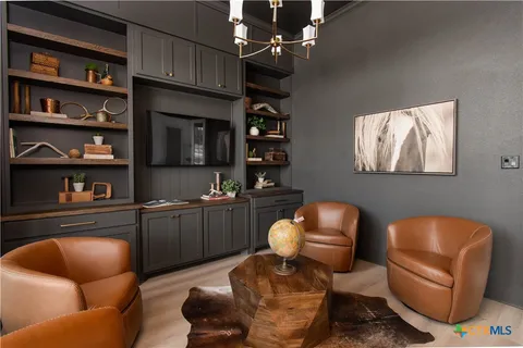 a living room with furniture workspace and window