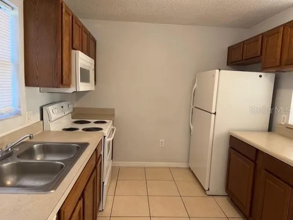 a kitchen with a sink a refrigerator and a sink