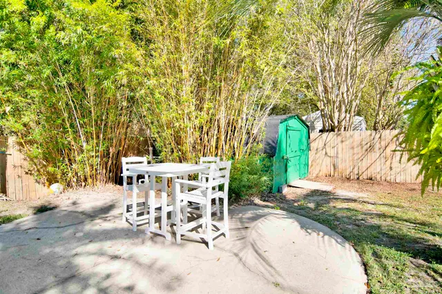 a view of a backyard with sitting area