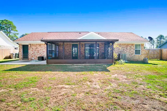 a view of a house with swimming pool and a yard
