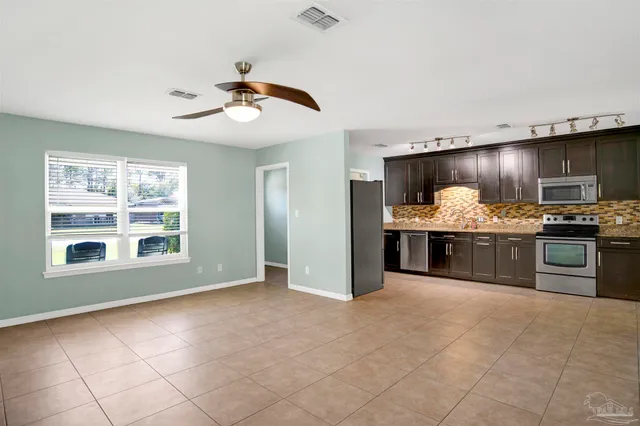 a view of a kitchen with a stove cabinets and chandelier