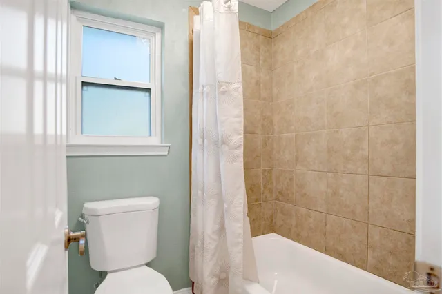 a white toilet sitting next to a bathroom sink