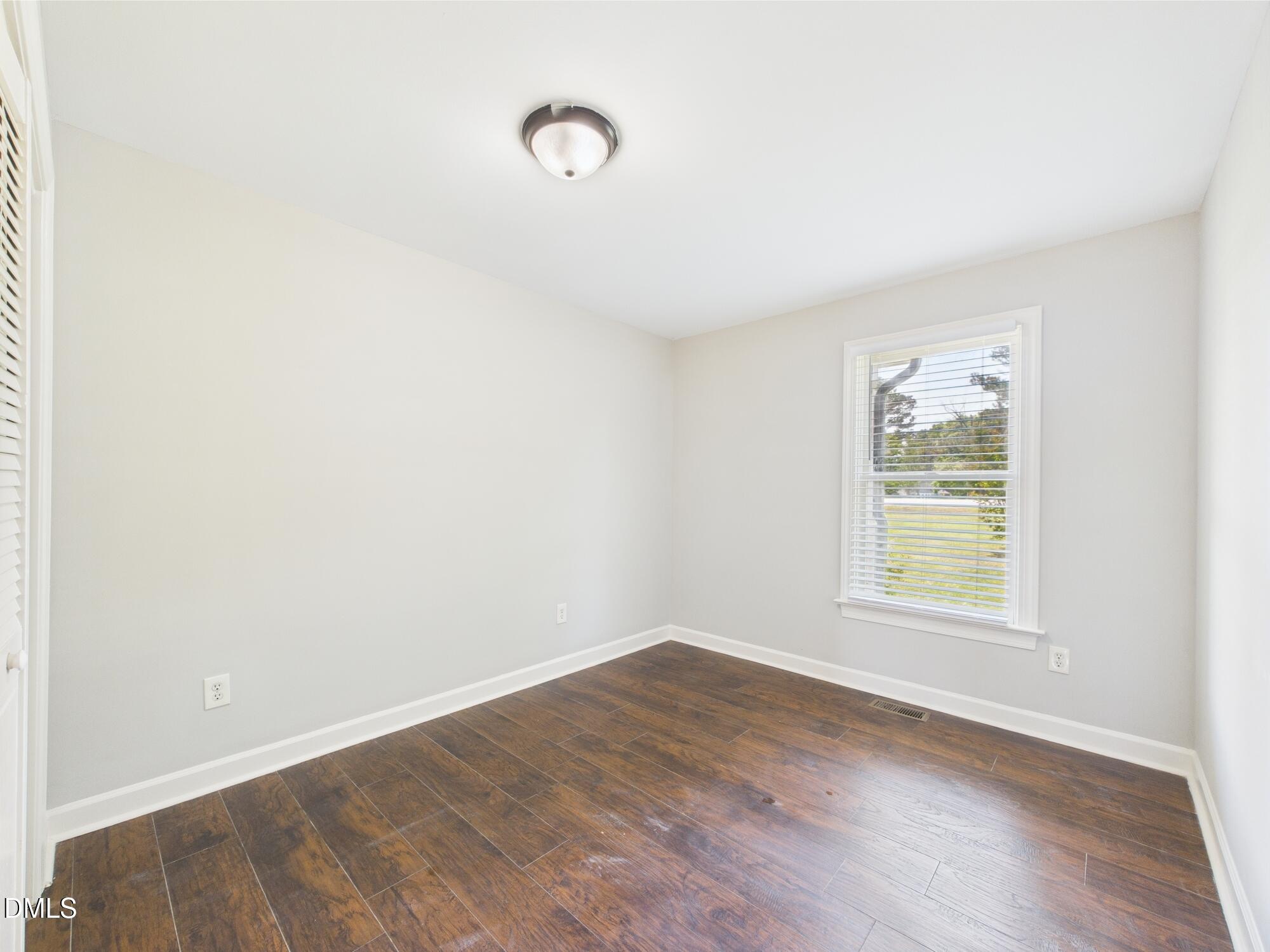 10917 Fanny Brown Road Raleigh, NC 27603 - Photo 37 of 54 an empty room with wooden floor and windows