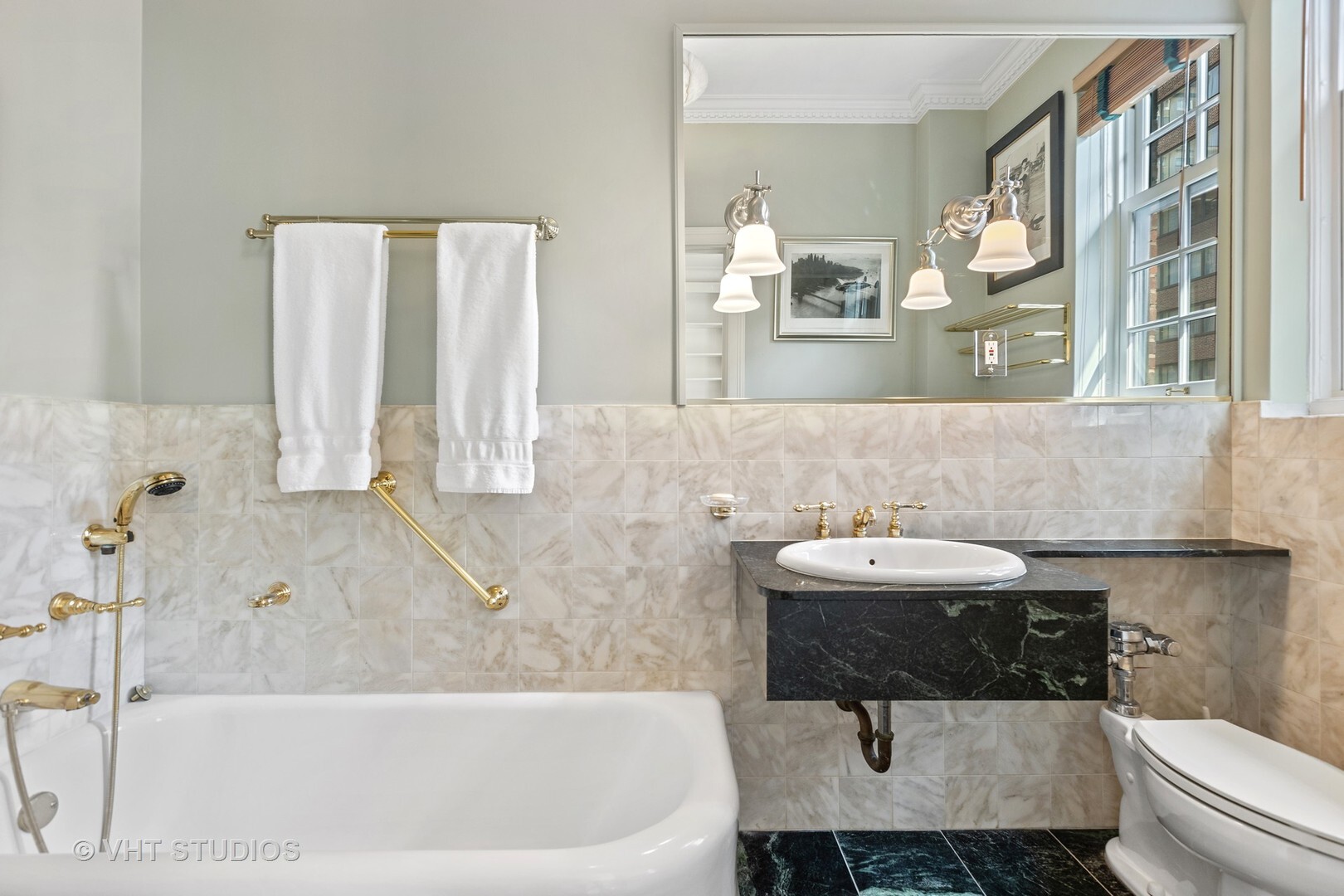 220 East Walton Place, Unit 9W Chicago, IL 60611 - Photo 15 of 22 a bathroom with a bathtub and a sink