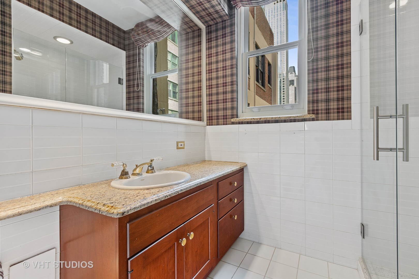 220 East Walton Place, Unit 9W Chicago, IL 60611 - Photo 20 of 22 a bathroom with a granite countertop sink and a mirror